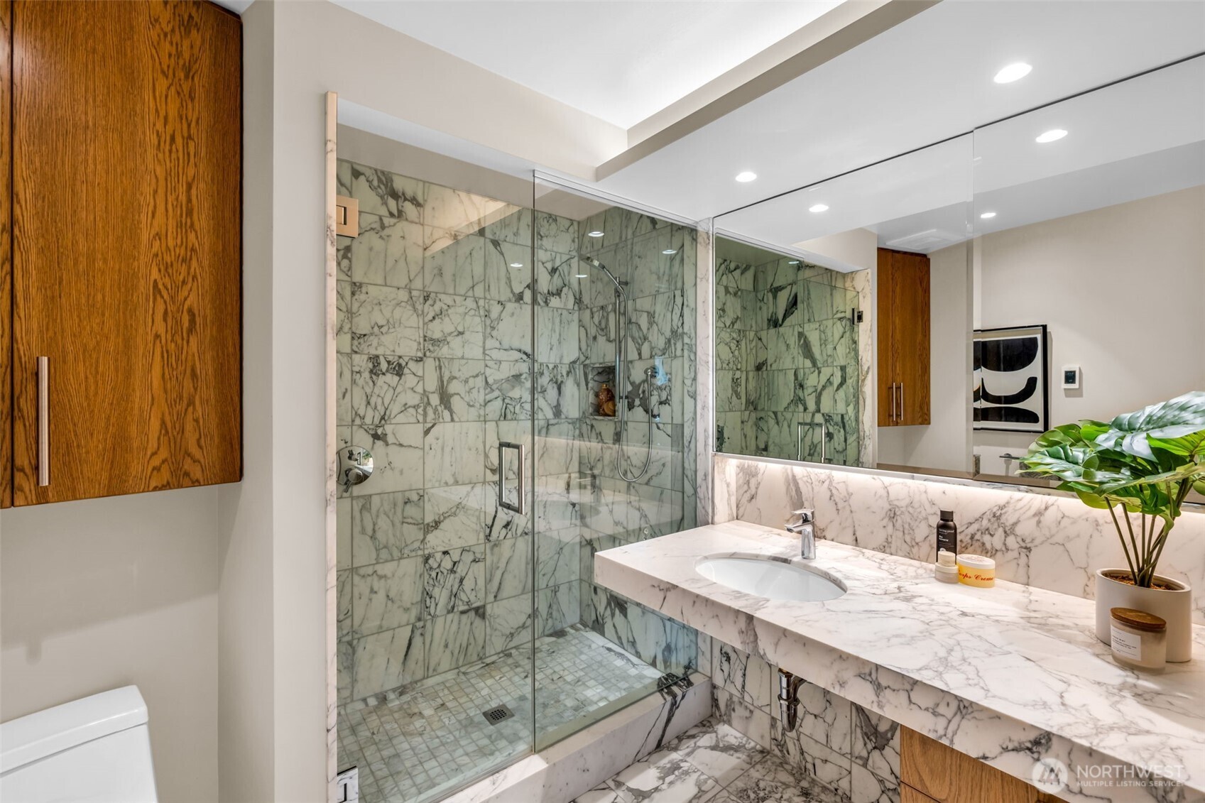 6437 Hampton Road South Seattle, WA 98118 - Photo 24 of 39 a spacious bathroom with a granite countertop sink a shower and a mirror