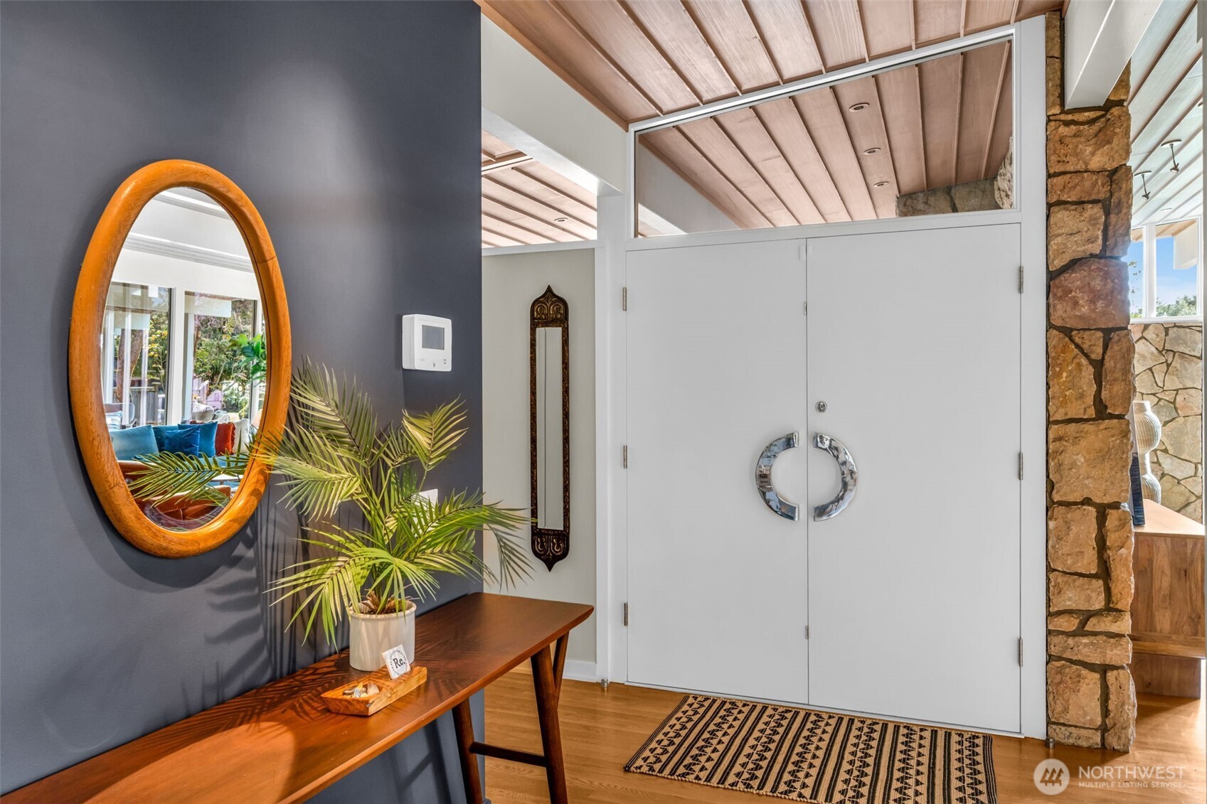 6437 Hampton Road South Seattle, WA 98118 - Photo 4 of 39 a front view of a house with garden equipment and glass windows