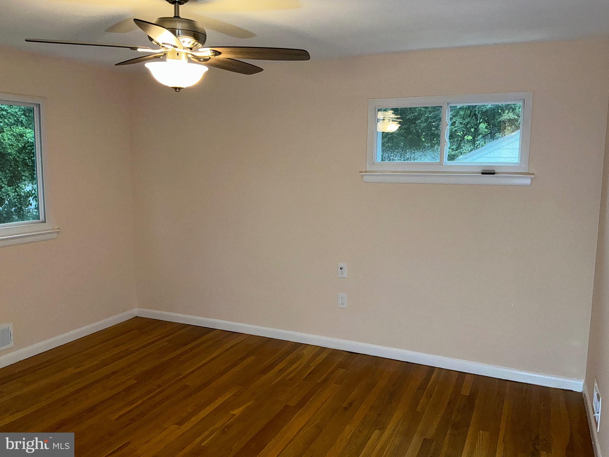 303 Charlton Court Silver Spring, MD 20902 - Photo 15 of 45 an empty room with wooden floor and windows