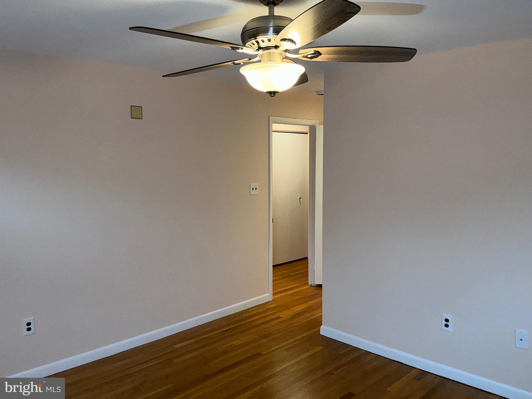 303 Charlton Court Silver Spring, MD 20902 - Photo 16 of 45 a view of an empty room with wooden floor