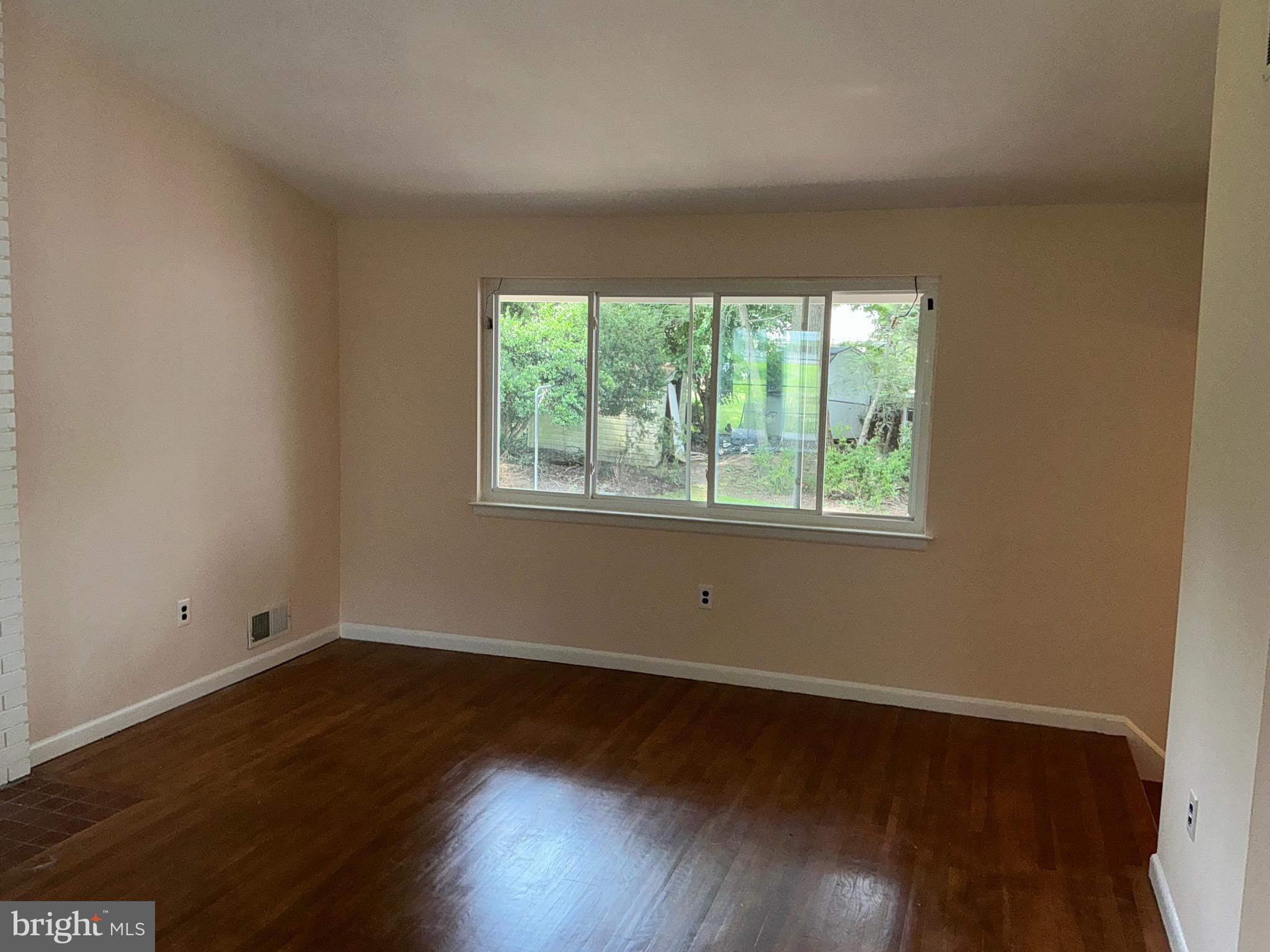 303 Charlton Court Silver Spring, MD 20902 - Photo 26 of 45 a view of a room with wooden floor and window