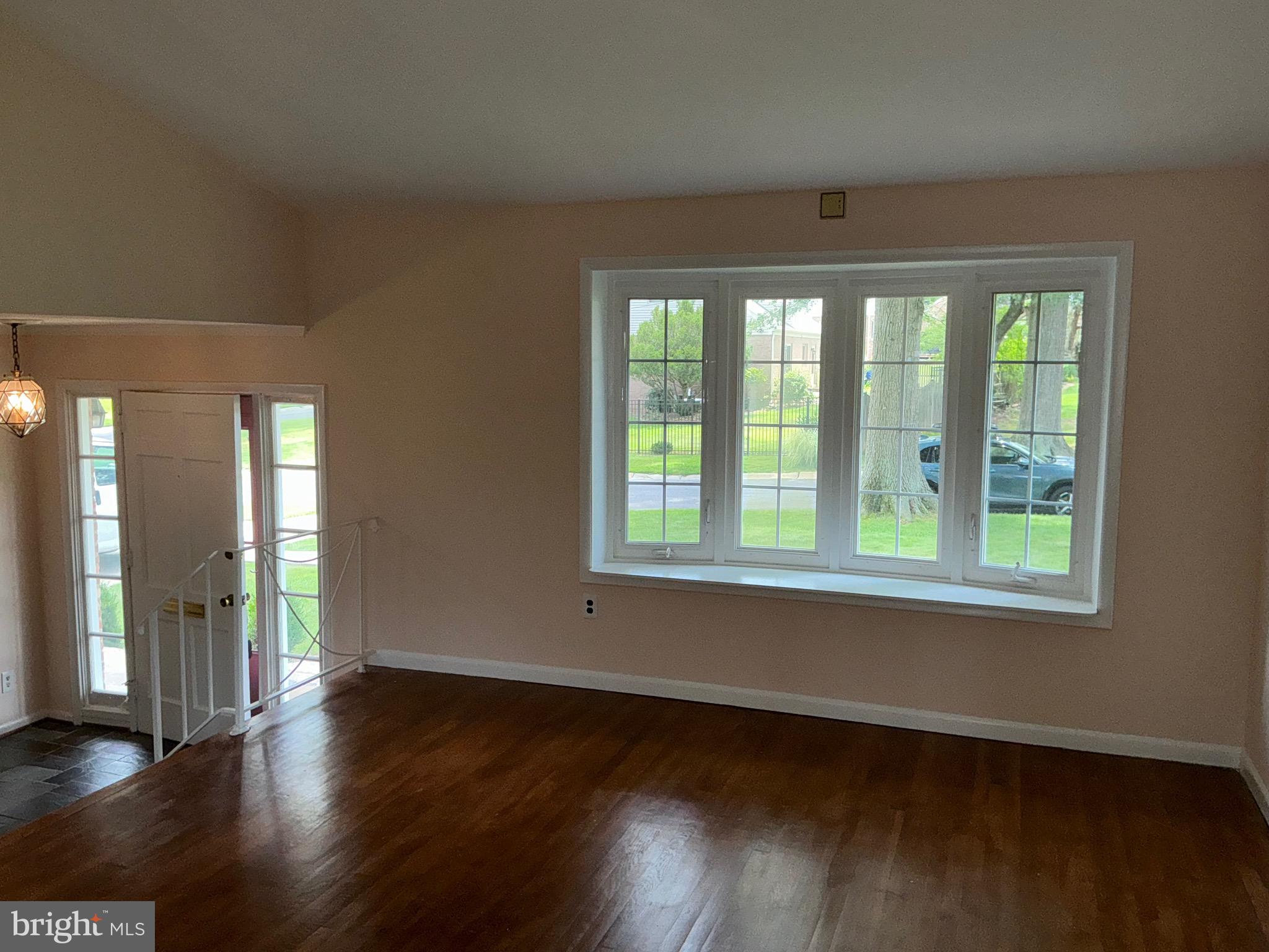 303 Charlton Court Silver Spring, MD 20902 - Photo 27 of 45 a view of an empty room with wooden floor and a window