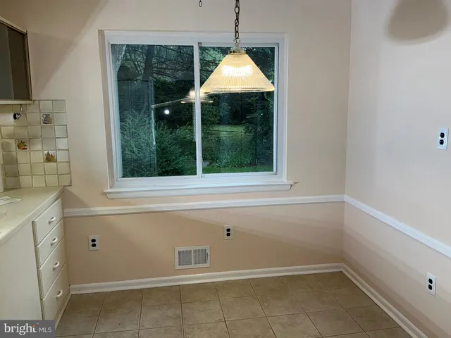 a view of a kitchen with a sink and window