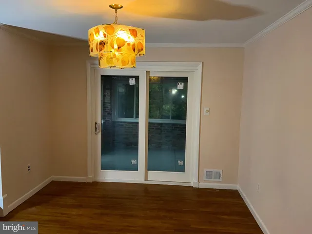 an entryway door with wooden floor