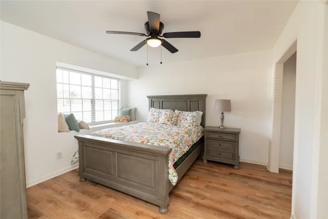 a bedroom with a bed and a ceiling fan