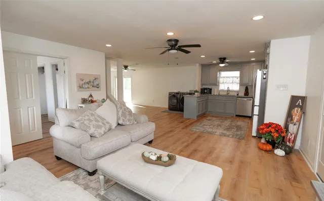 a living room with furniture and a chandelier