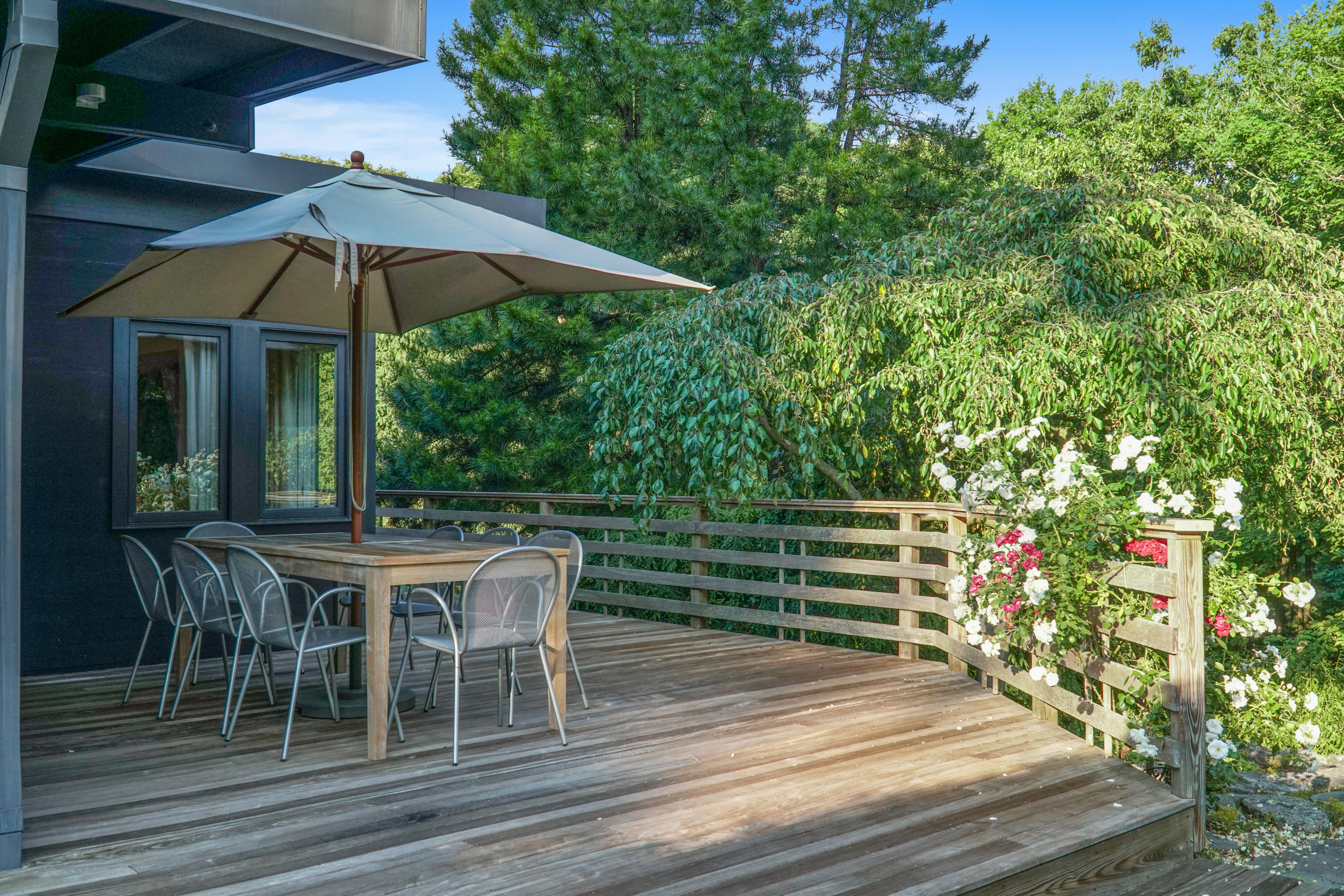 Undisclosed Address Wilton, CT 06897 - Photo 20 of 25 a view of a patio with table and chairs under an umbrella
