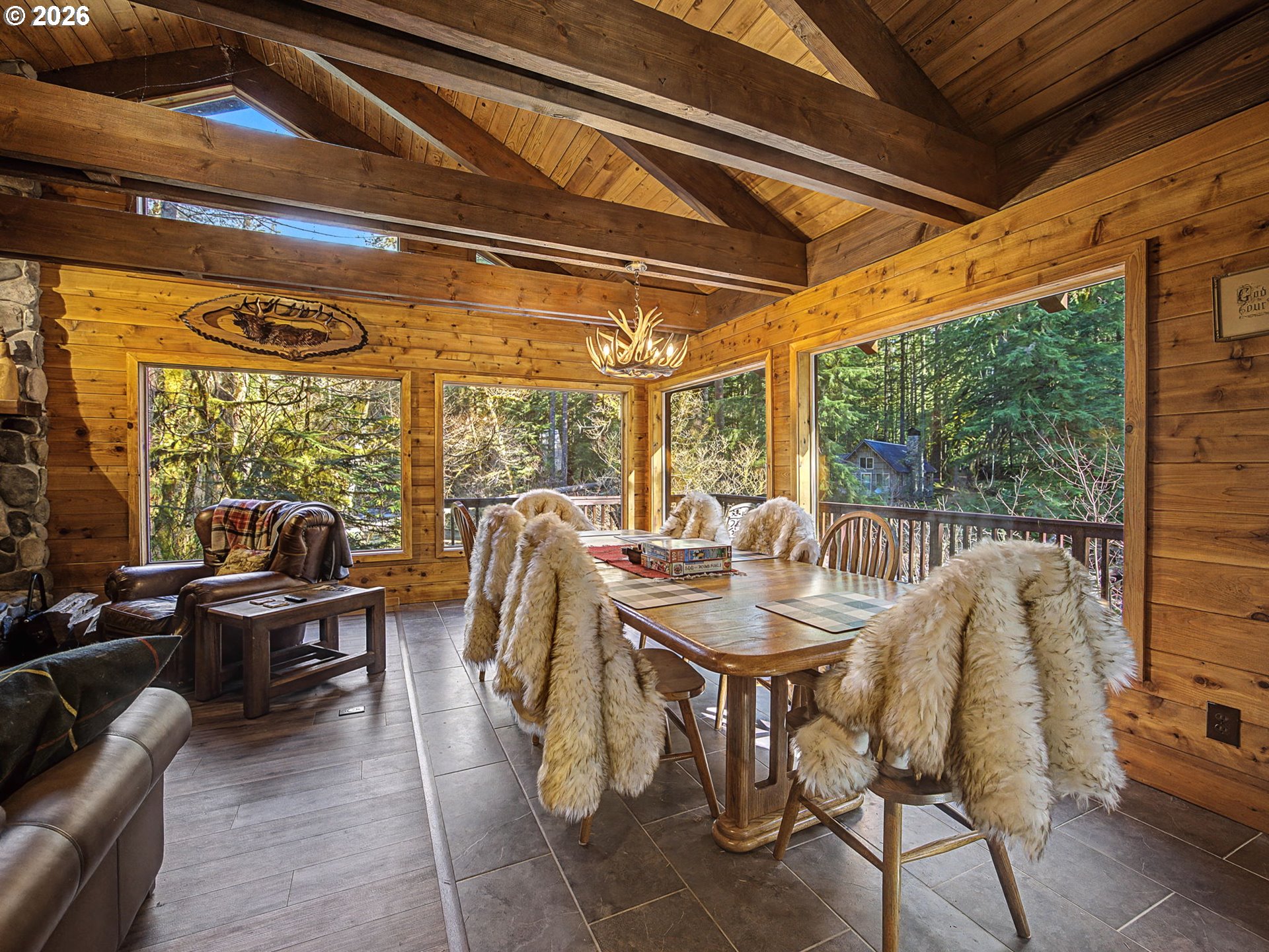 28910 Road 12 Rhododendron, OR 97049 - Photo 11 of 48 a view of a dining room with furniture wooden floor and a chandelier