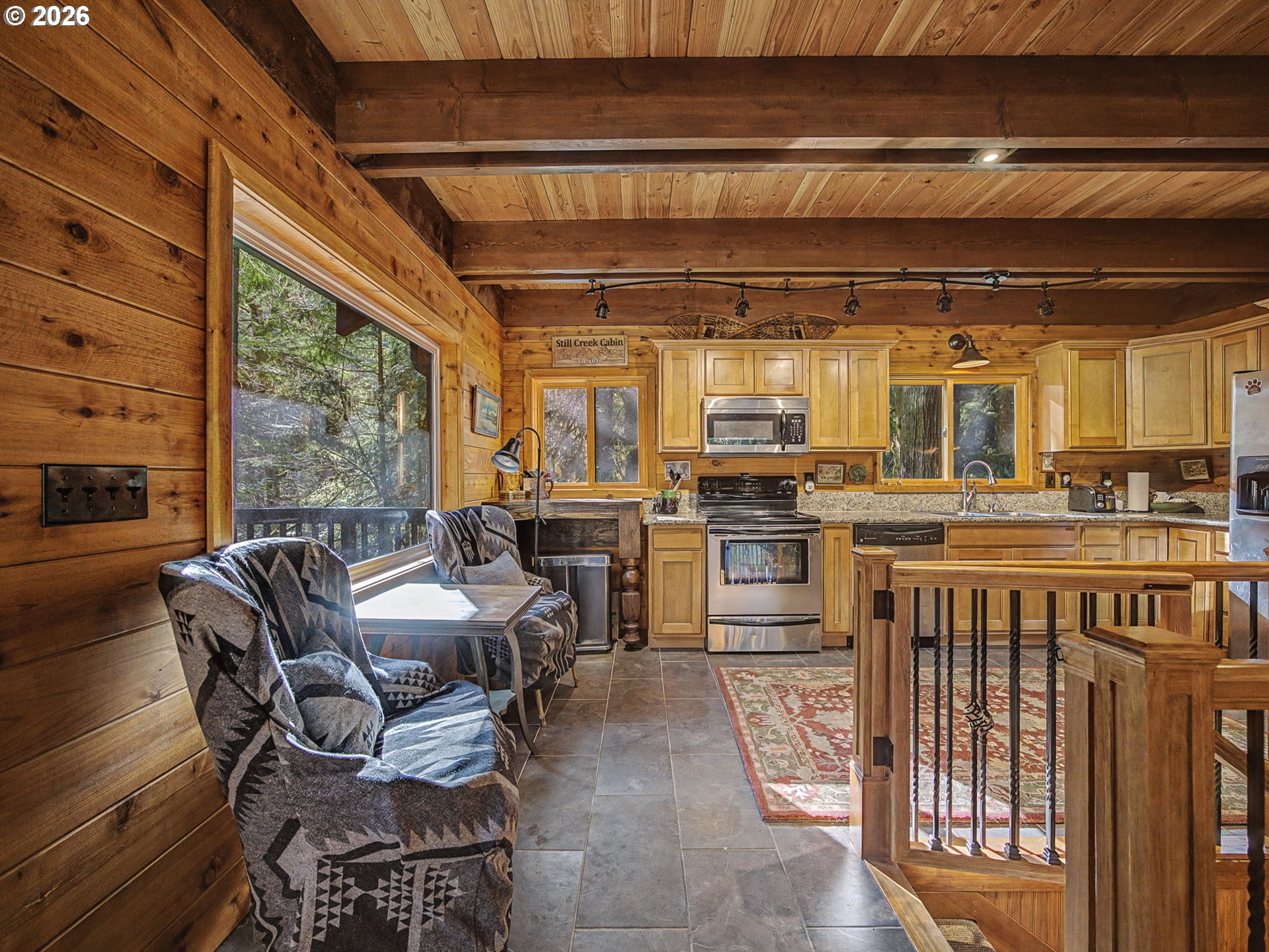 28910 Road 12 Rhododendron, OR 97049 - Photo 12 of 48 a kitchen with stainless steel appliances kitchen island granite countertop a sink and cabinets