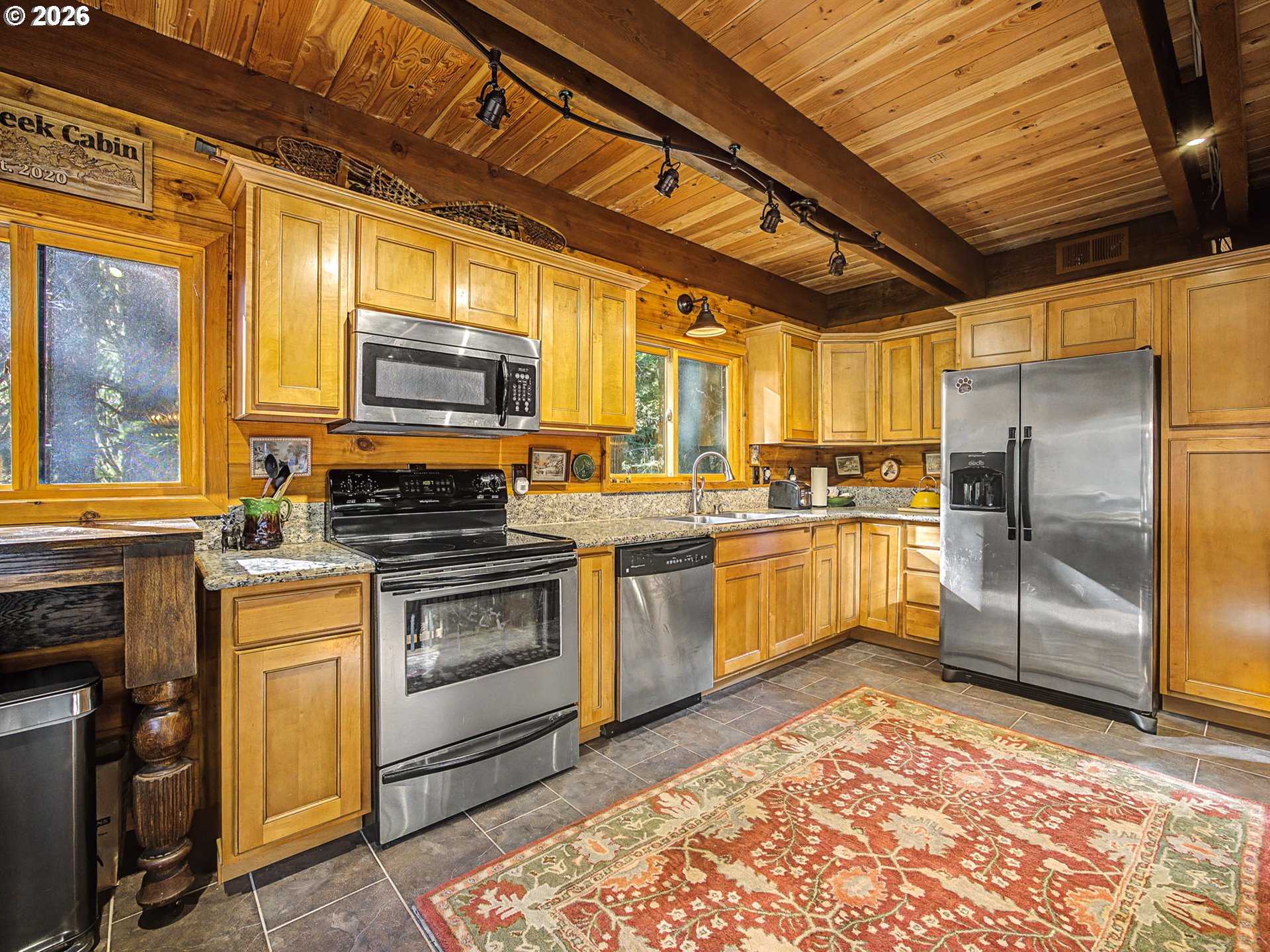 28910 Road 12 Rhododendron, OR 97049 - Photo 13 of 48 a kitchen with a refrigerator and a stove top oven