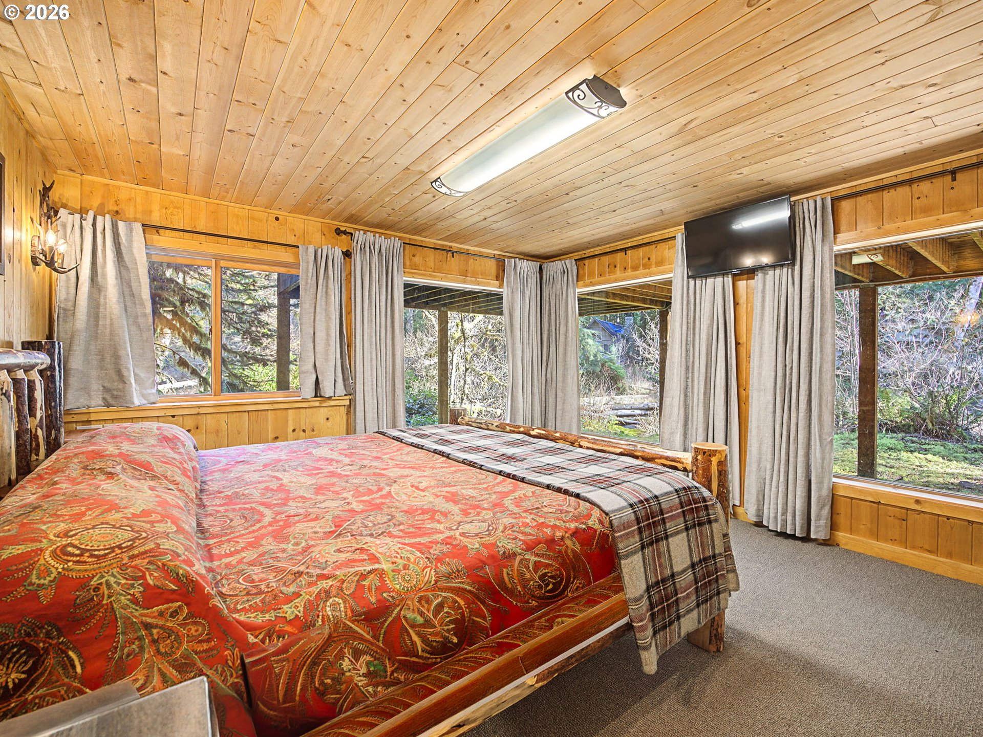 28910 Road 12 Rhododendron, OR 97049 - Photo 19 of 48 a bed sitting in a spacious bedroom next to a window