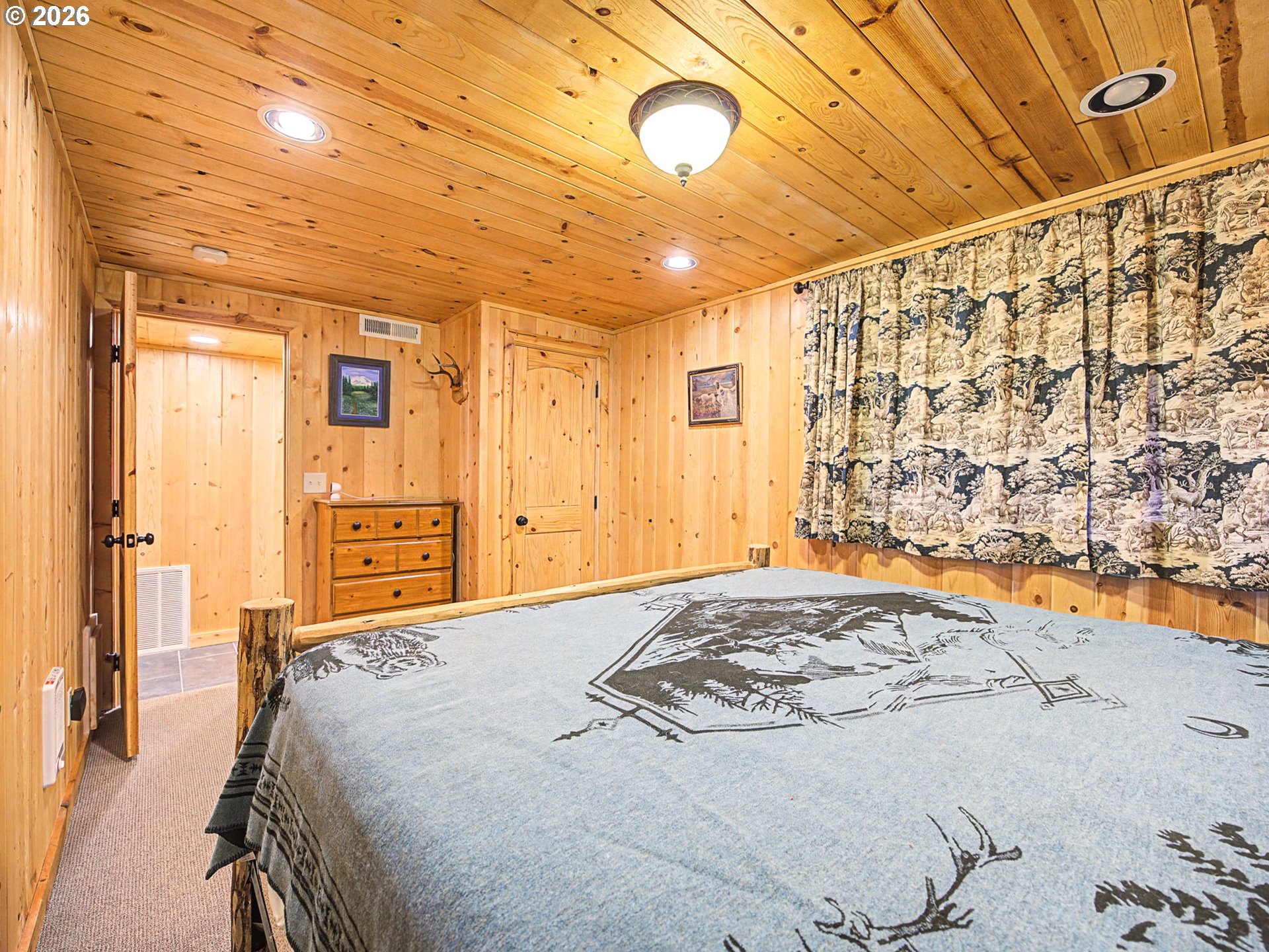 28910 Road 12 Rhododendron, OR 97049 - Photo 25 of 48 a bedroom with a bed and a chandelier