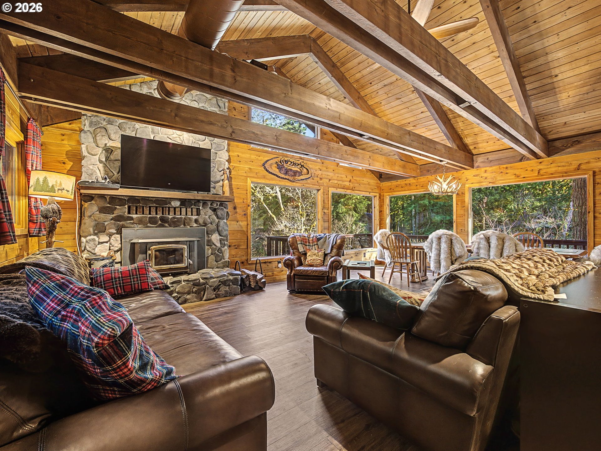 28910 Road 12 Rhododendron, OR 97049 - Photo 5 of 48 a living room with furniture a fireplace and a flat screen tv