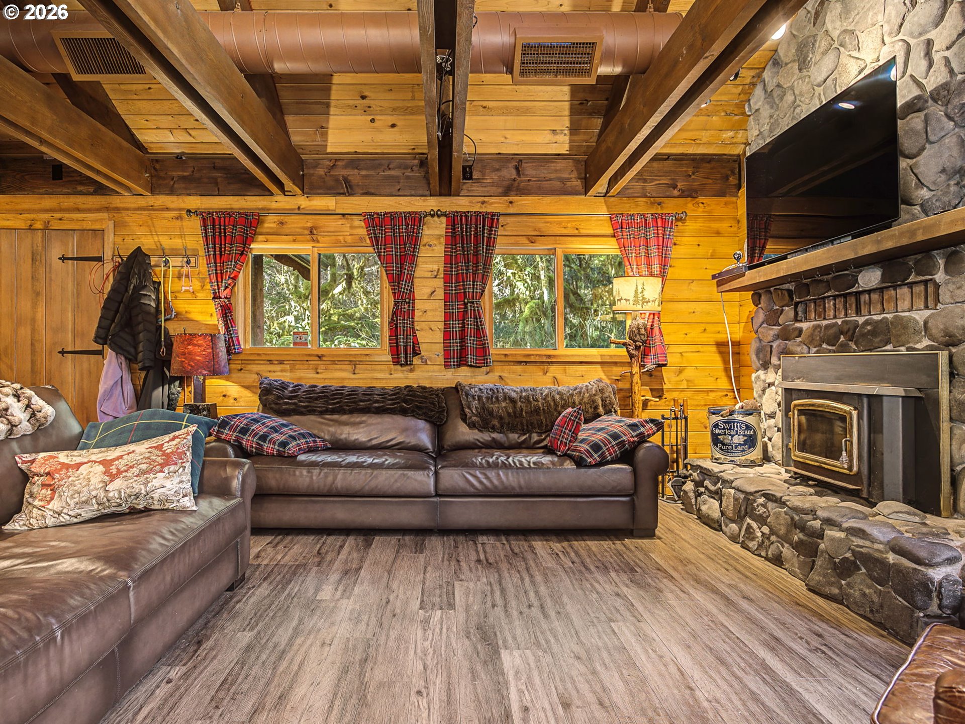 28910 Road 12 Rhododendron, OR 97049 - Photo 7 of 48 a living room with furniture a flat screen tv and a fireplace