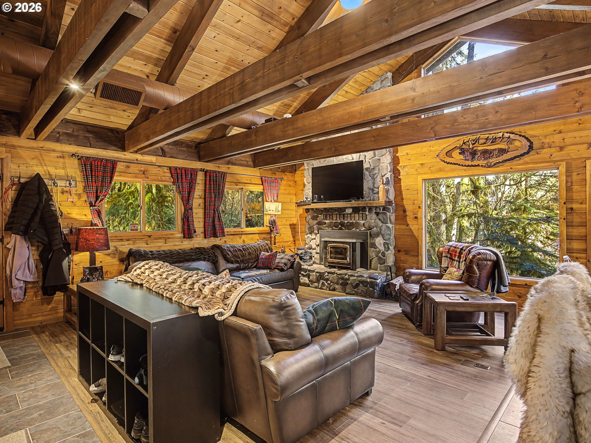 28910 Road 12 Rhododendron, OR 97049 - Photo 8 of 48 a living room with furniture a fireplace and a flat screen tv