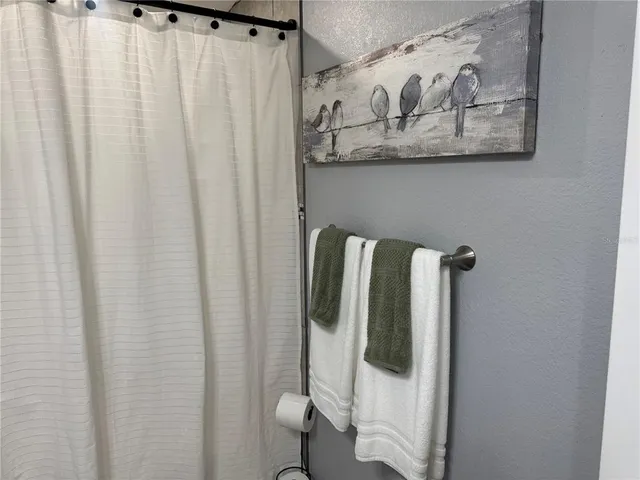 a close view of a bathroom with a shower curtain