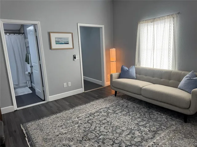 a living room with a couch and a rug