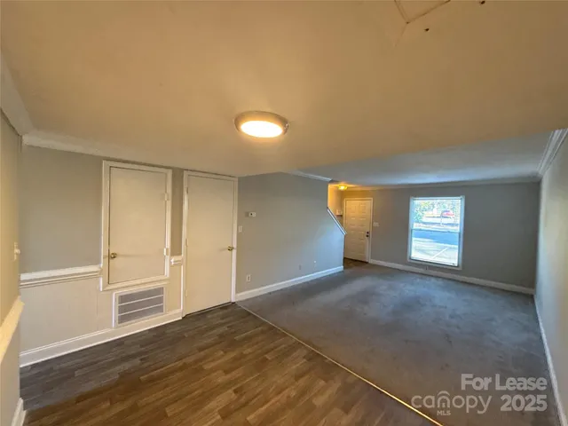 an empty room with a empty space and windows