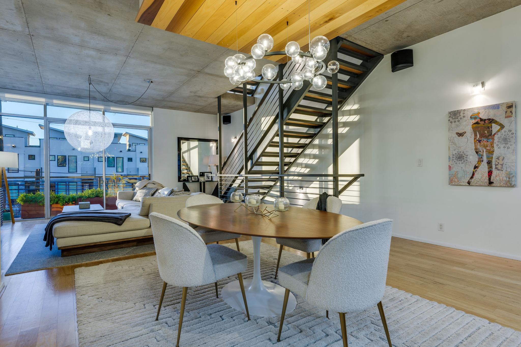 2301 South 5th Street, Unit 5 Austin, TX 78704 - Photo 11 of 39 Dining space with hardwood / wood-style flooring, a wall of windows, and a chandelier