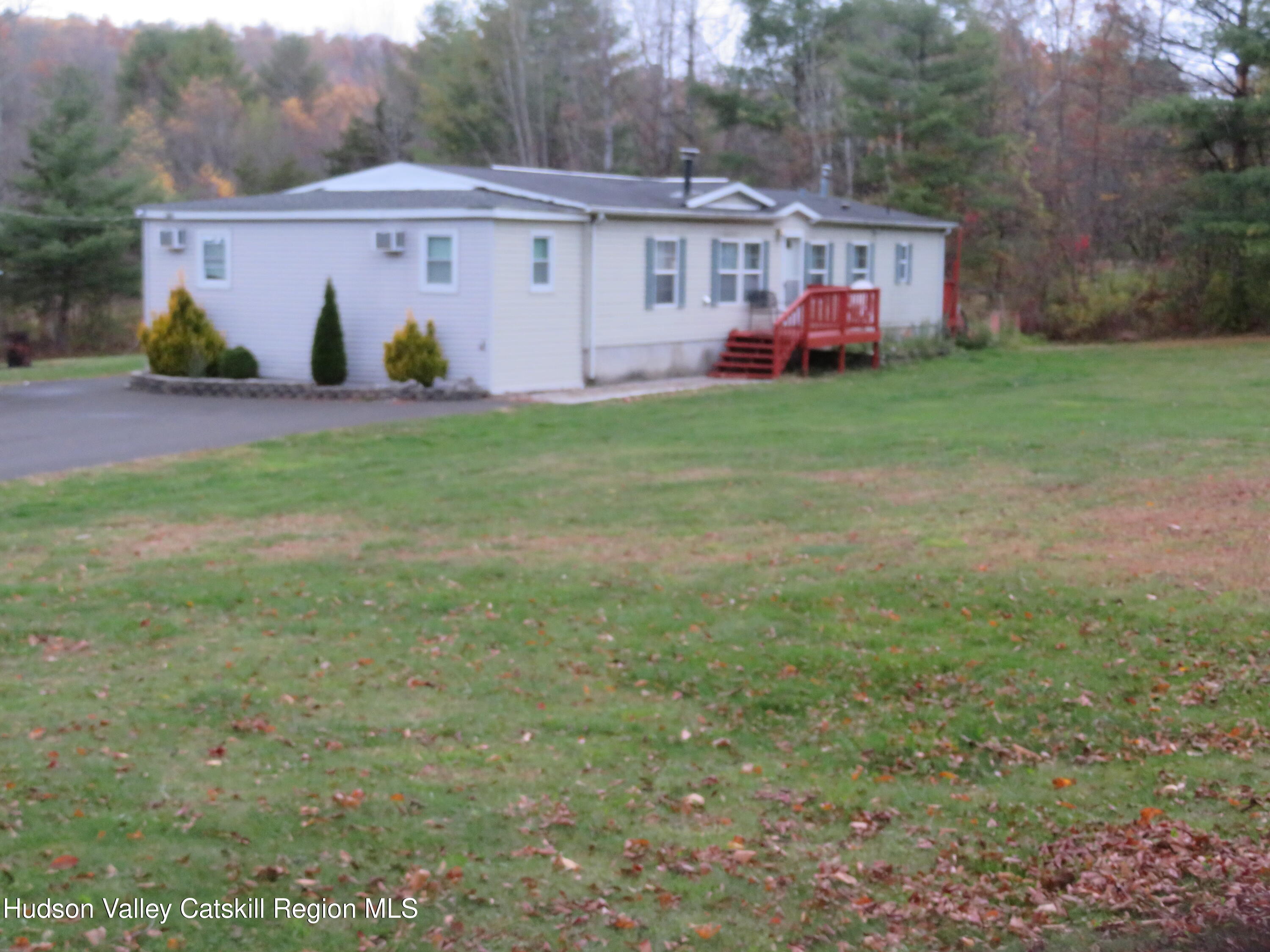 a view of a house with a yard and sitting area