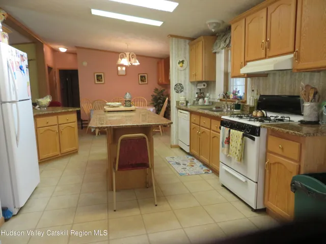 a kitchen with cabinets and chairs
