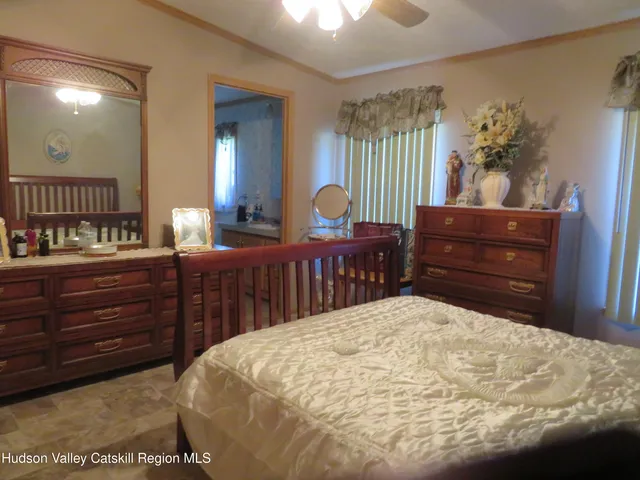 a bedroom with a bed and a dresser