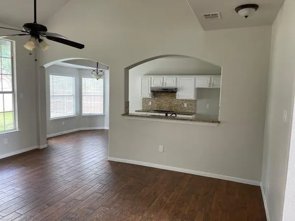 wooden floor in an empty room with a window