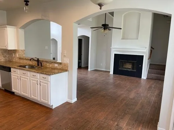 a kitchen with sink cabinets and a fireplace