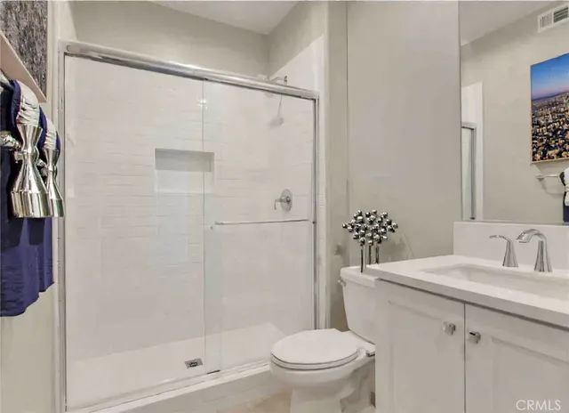 a bathroom with a shower a toilet and sink