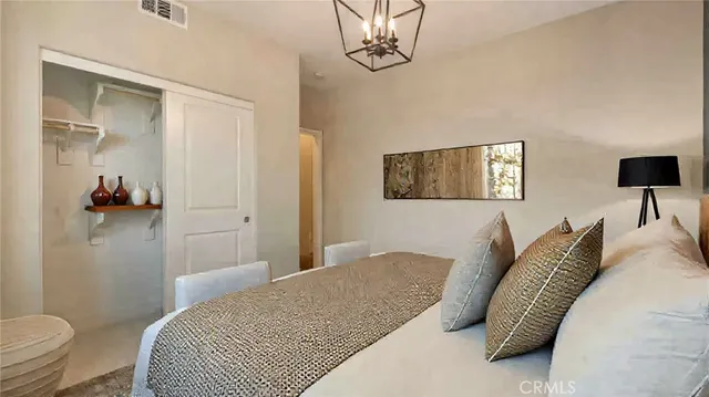 a bedroom with a bed and a chandelier