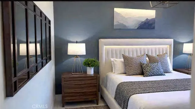 a bedroom with a bed and a painting on the wall