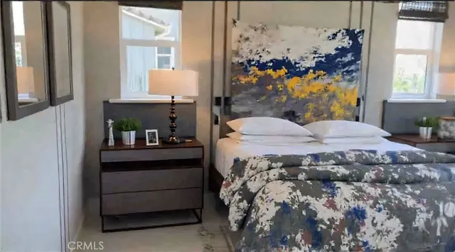 a bed sitting in a bedroom next to a window