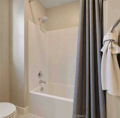 a white bath tub sitting next to a white toilet