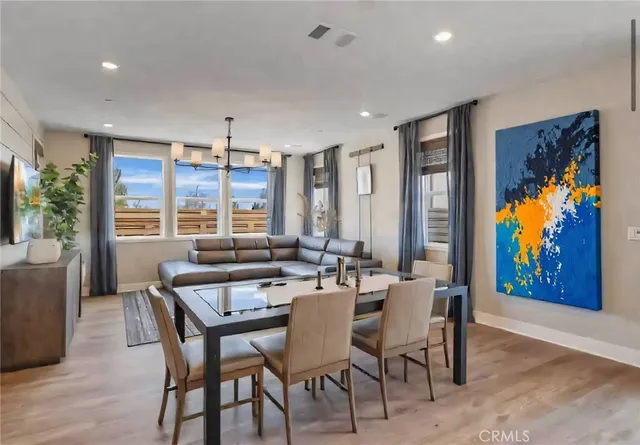 a view of a dining room with furniture large window and wooden floor