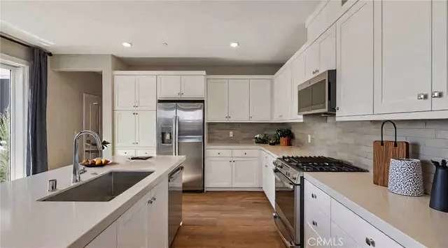 a kitchen with refrigerator a sink and cabinets