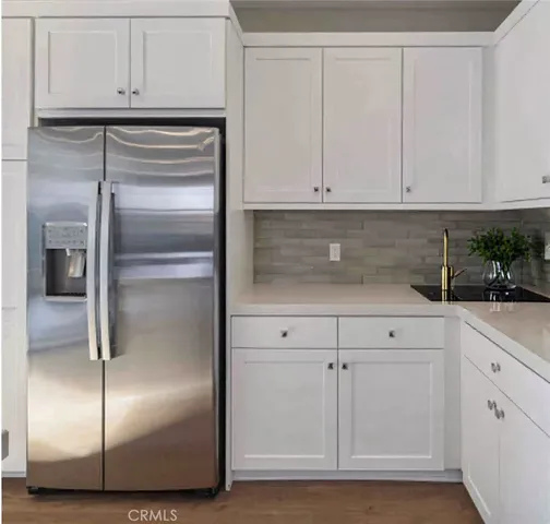 a kitchen with white cabinets and white stainless steel appliances