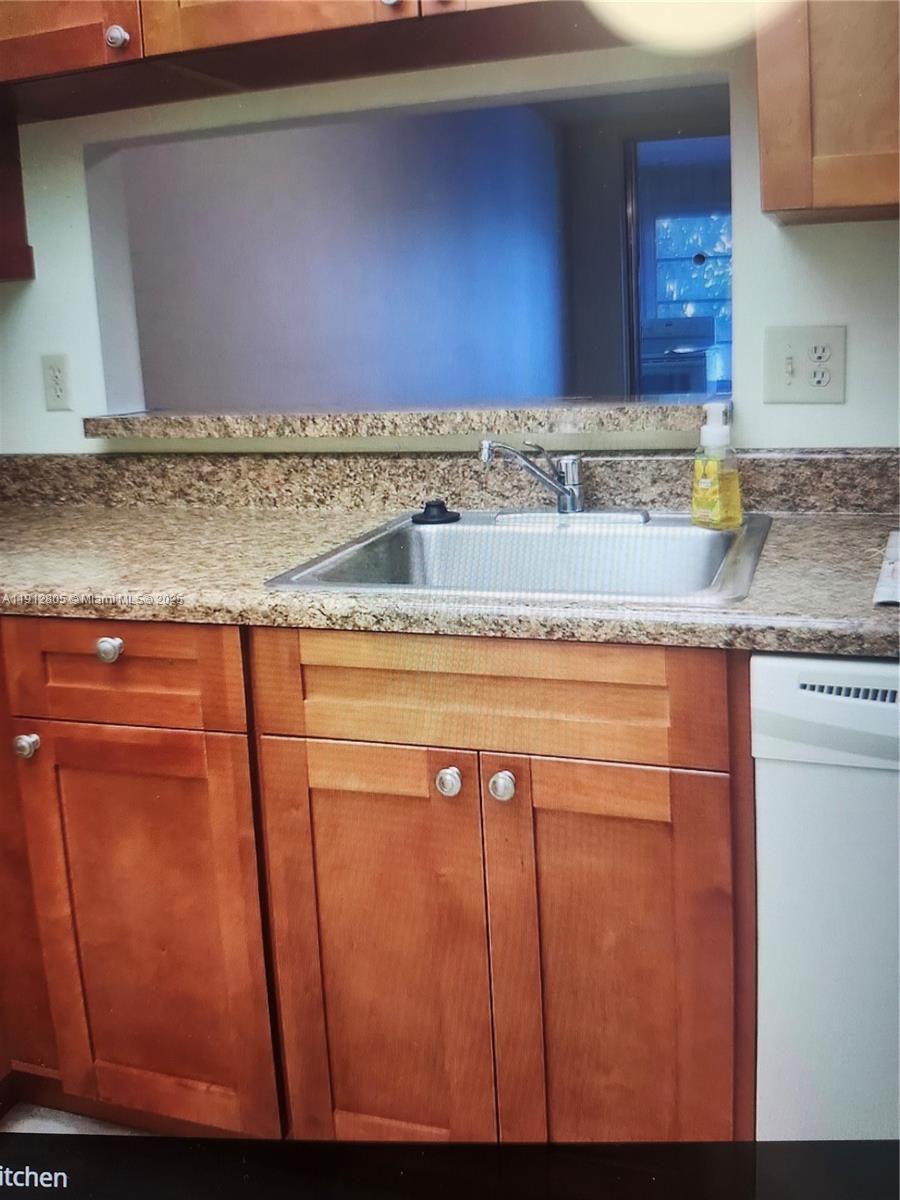 9450 Poinciana Place, Unit 205 Davie, FL 33324 - Photo 8 of 9 a sink with granite countertop cabinets