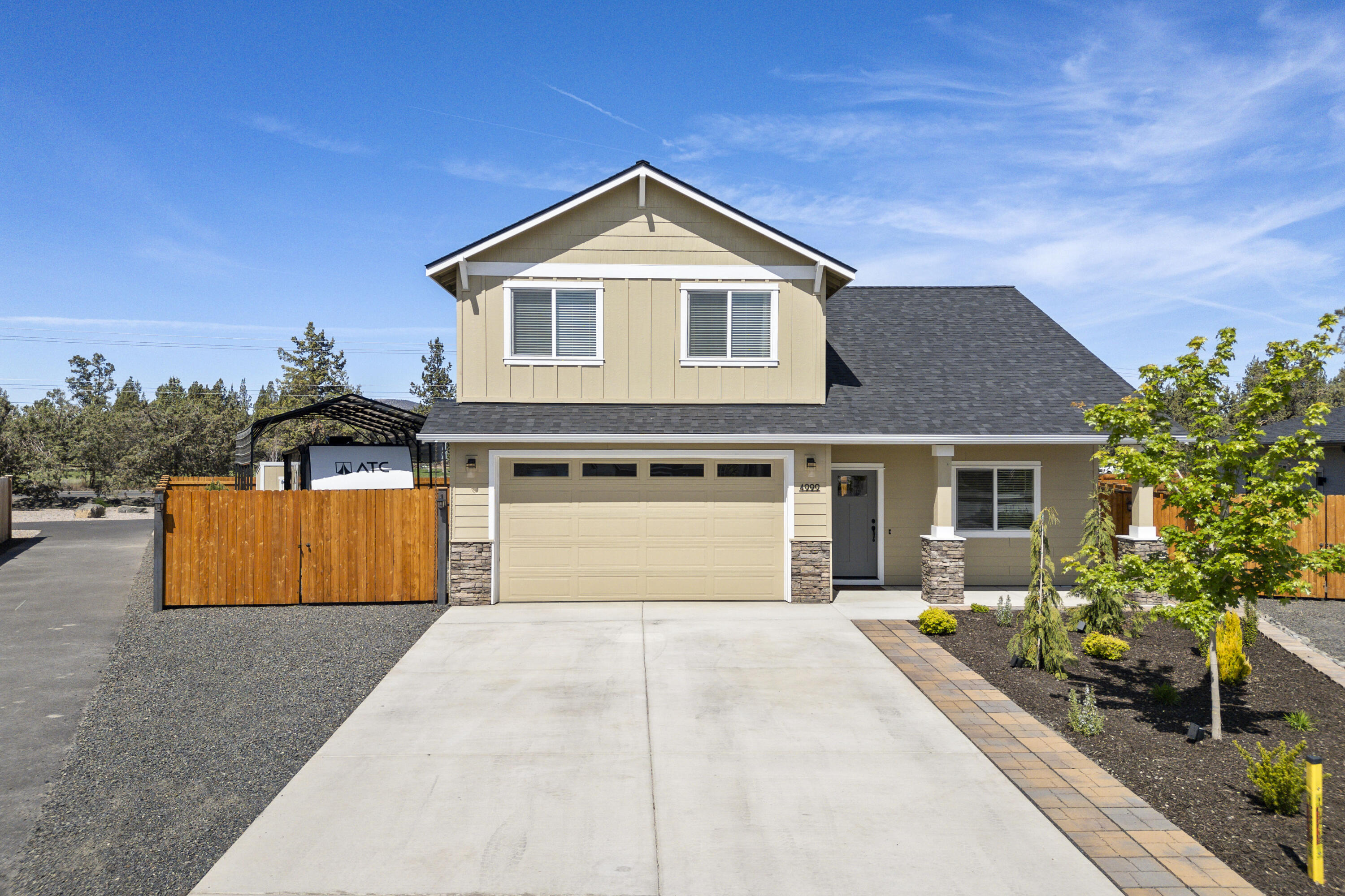 4999 Southwest Yew Place Redmond, OR 97756 - Photo 2 of 50 a front view of house with yard and trees in the background