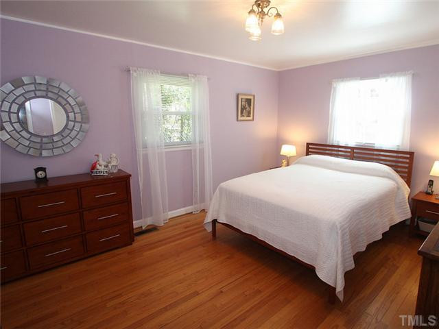 4307 Malvern Road Durham, NC 27707 - Photo 11 of 18 The owner's bedroom has lovely hardwoods and natural light streaming in.