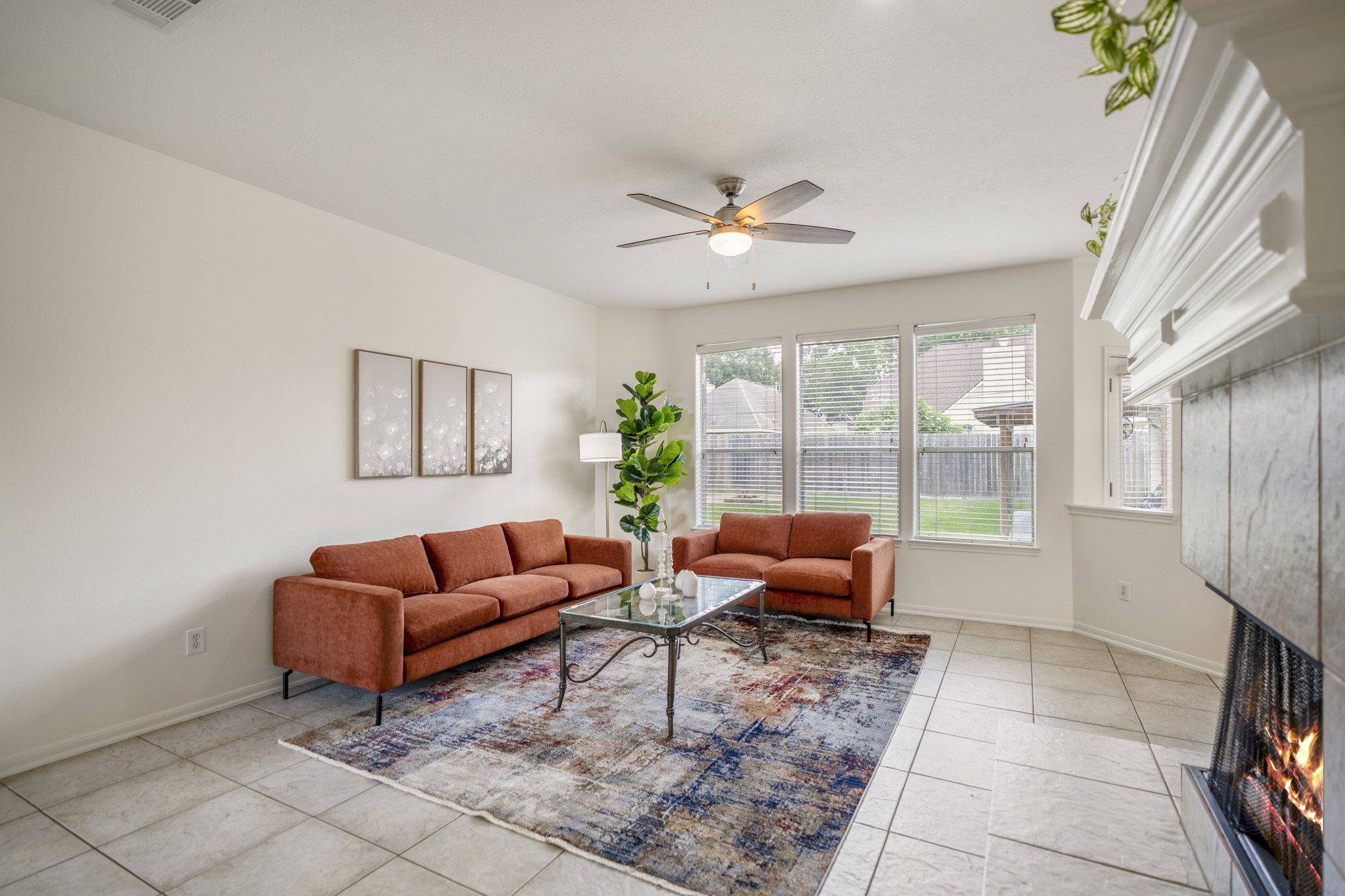 19106 South Rim Trail Spring, TX 77388 - Photo 18 of 50 This intimate angle of the living room highlights the warmth of the fireplace with the tile floors underfoot and the natural lighting streaming in through the windows along the back. To our left a hallway leads to the primary suite.