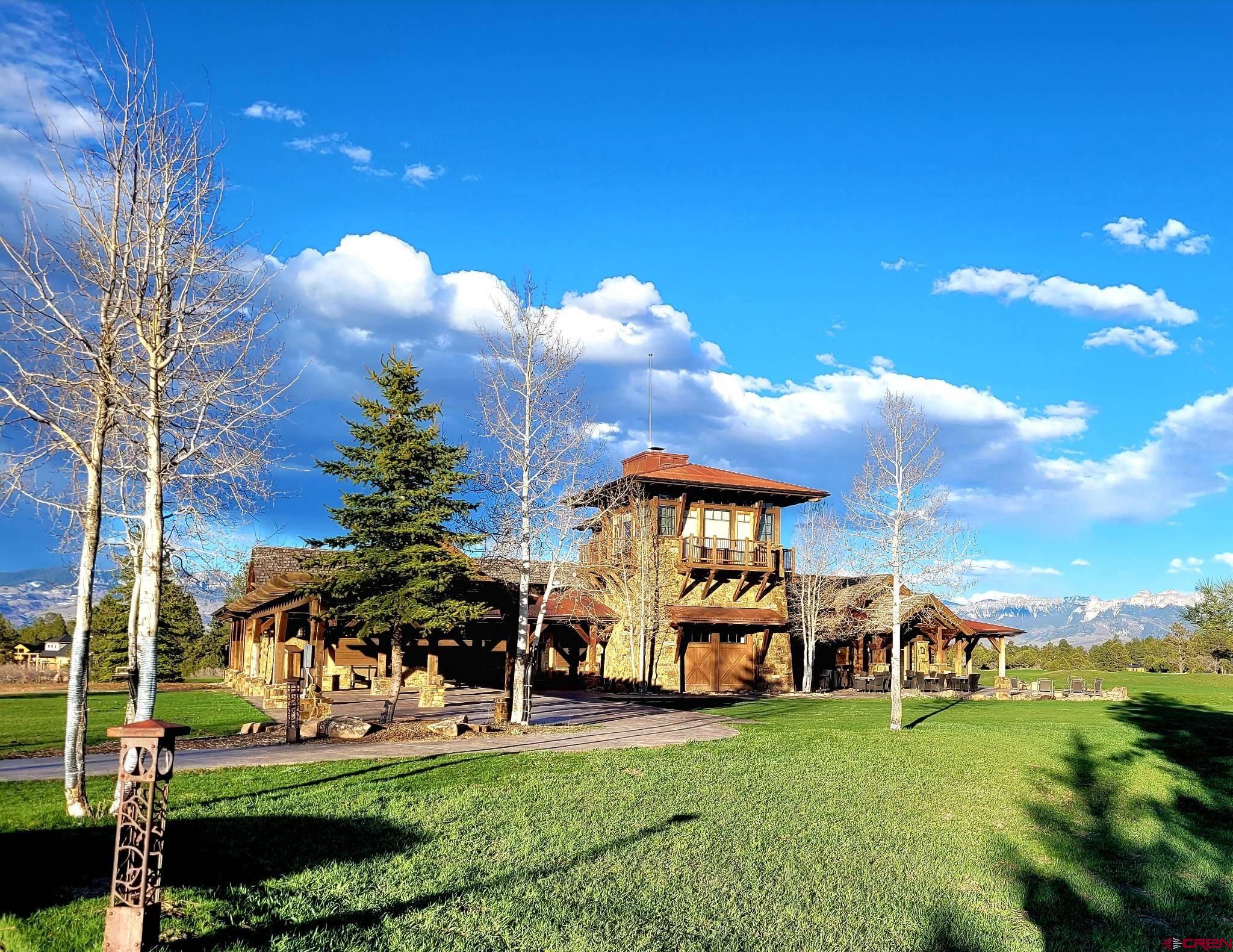 225 South Badger Trail Ridgway, CO 81432 - Photo 7 of 8 a front view of a house with garden and trees