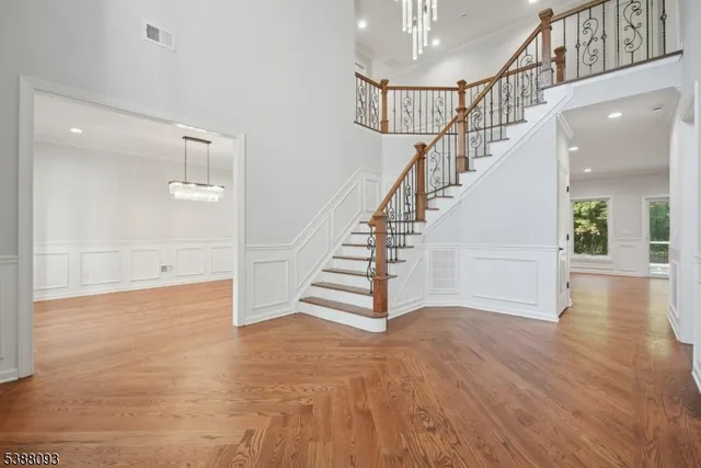 a view of entryway and hall with wooden floor