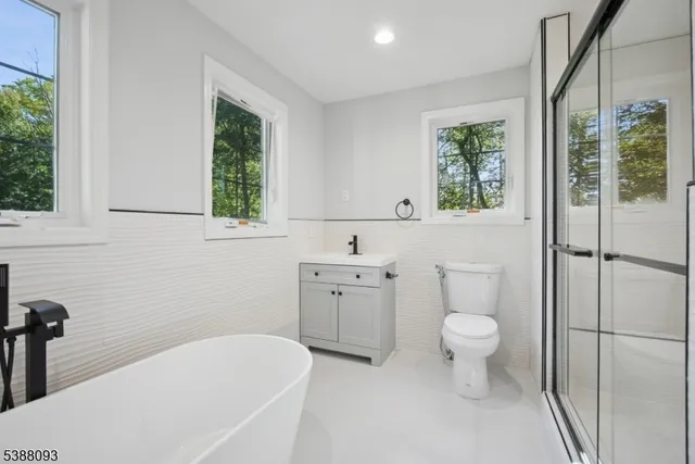 a bathroom with a toilet sink and window
