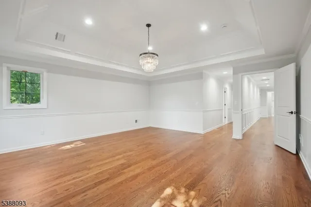 a view of a room with wooden floor and window
