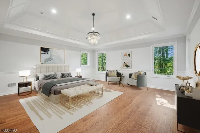 a bedroom with furniture and a large window