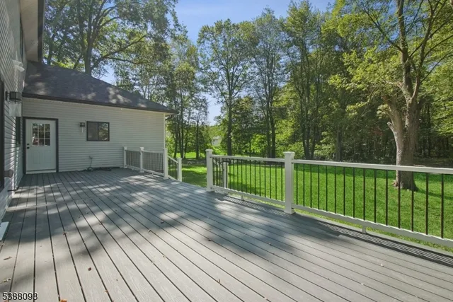 a view of a backyard with wooden floor and fence