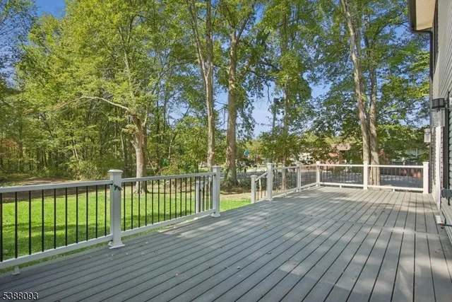 a view of a patio with wooden floor and fence