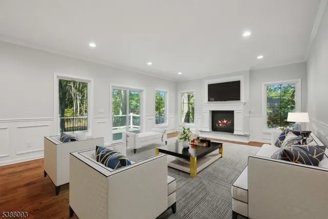 a living room with furniture a large window and a fireplace