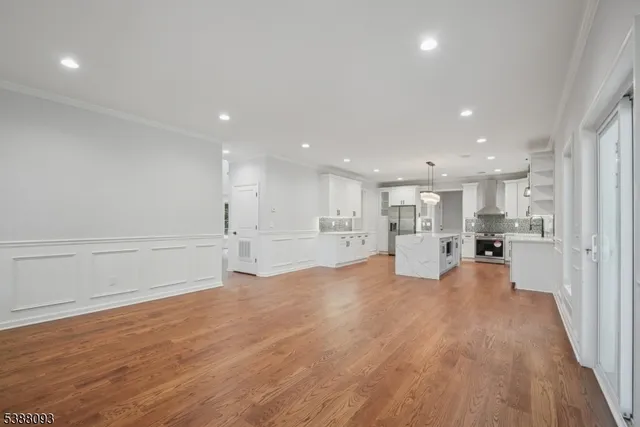 a view of kitchen with kitchen island and stainless steel appliances