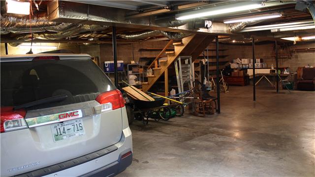 255 Biggs Road Cottontown, TN 37048 - Photo 13 of 18 The basement is huge. There is plenty of room for 2 vehicles with room to spare. At the far end from the entry, the previous owner installed a massive workbench with a peg board on the wall for all your tools.